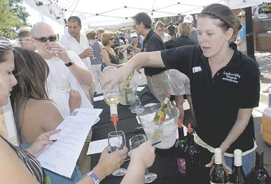 Melissa Yester of Loudoun Valley Vineyards, pours samples of wines for attendees of the 20th Annual Labor Day Jazz and Wine Festival held in Herndon on Labor Day 2008. Wineries from around the region provided the wine while several jazz bands provided the musical entertainment.