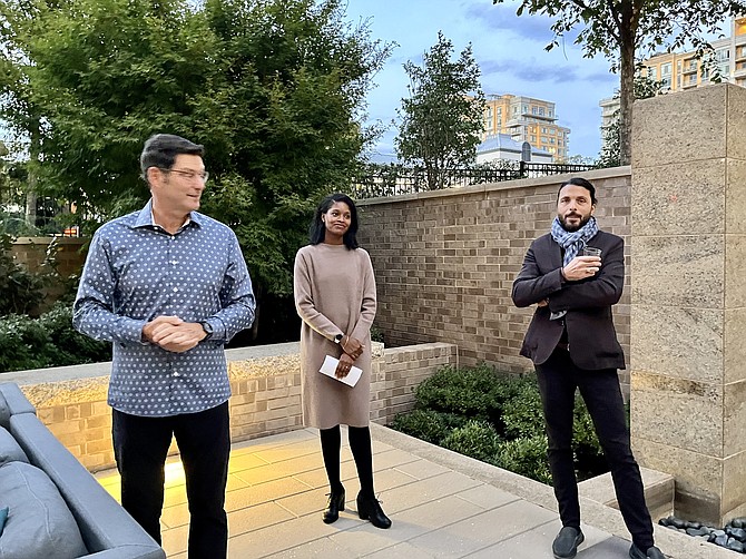 Artist Andrea Limauro (right) discusses his work with Robert Goudie, executive director the nonprofit organization Greater Reston Arts Center, rebranded as Tephra Institute of Contemporary Art (Tephra ICA), and Lisa Mariam, director of grants and services at  ArtsFairfax during the opening reception of his exhibition "A Rising Tide Lifts All Boats, 2018."