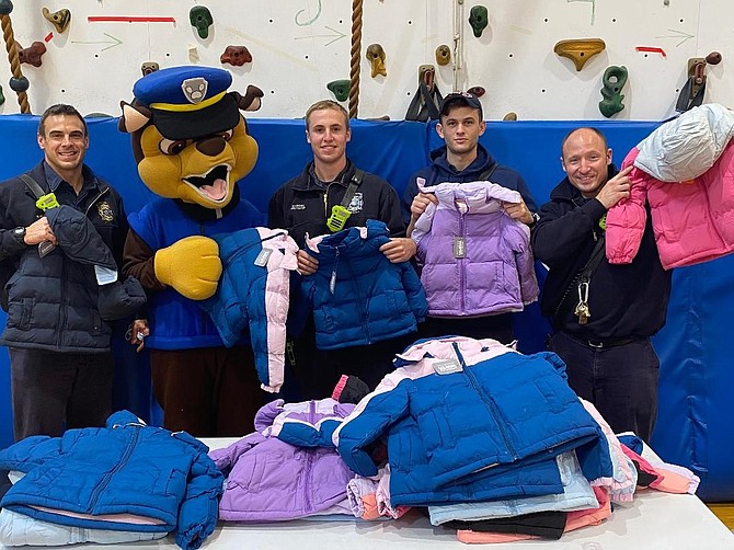 Volunteers gather as part of the annual Firefighters and Friends to the Rescue coat drive distribution Oct. 30 at Samuel Tucker Elementary School.