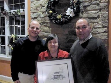 Pictured with retiring Churchill Road cafeteria cashier Margaret Liappis are her son Nick Liappis, a Churchill Road alum, (left), and Don Hutzel, CRS principal.