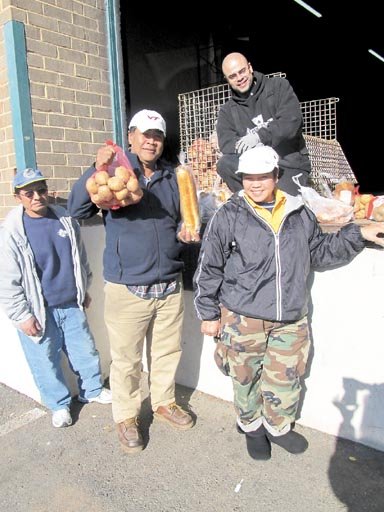 Leo Delgado hands out food staples, such as bags of potatoes, to Juan, Rocky and Nancy, who depend on organizations such as Food for Others. Located in Fairfax, Food for Others is the largest distributor of free food directly to people in need in Northern Virginia, provides the assistance needed by unemployed and low-income neighbors.