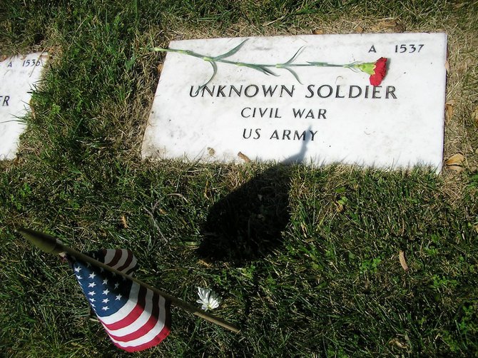 Carnations and flags decorate the graves of 113 unknown soldiers at the Alexandria National Cemetery. 