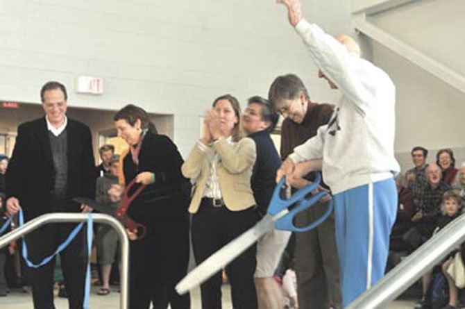 From right, George Strollo, Arlington County Board Chair Mary Hughes Hynes, School Board members Abby Raphael, Libby Garvey and School Superintendent join with others to cut the ribbons to the newly opened center.