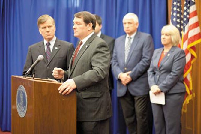 Governor Bob McDonnell (left) listens as Springfield Supervisor Pat Herrity comments on legislation to reduce "unnecessary" mandates on localities during a news conference in Richmond Monday, Jan. 16. 