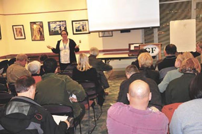 Pfc. Katy Defoe, Crime Prevention Officer for the Fairfax County Police Reston District Station, speaks to Great Falls homeowners representatives at the Great Falls Library Tuesday, Jan. 10. 