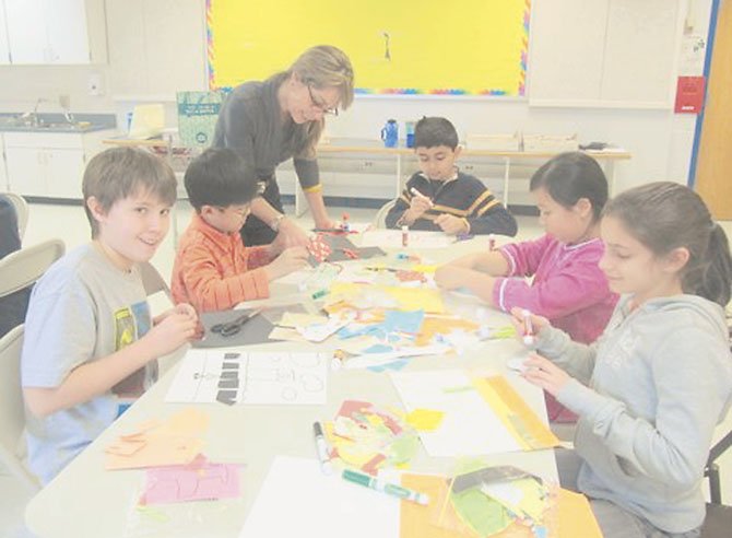 Churchill Road fourth graders get tips on how to make a collage expressing some aspect of their lives from Sharon Fishel of McLean Project for the Arts. Pictured from left to right are Jack Greehan, Kwanwoo Park, Sharon Fishel, Armin Bagha, Zoe Gomez-So and Sydney Bamdad.
 
