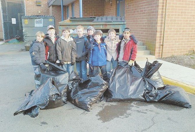 Webelo Pack #665 members pose with the bags of debris that they collected from the Churchill Road School grounds. From left to right are Walker Haynes, Gabriel Wimmer, Drew Myers, Cole Stitt, Ethan O’Donovan, Connor Graves, Chris Barre and Zubair Choudhury.

