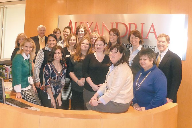 The combined staff of ACVA, AEDP and SBDC gather in the reception area Jan. 18 during the open house for ACVA's new offices at 625 N. Washington St. 