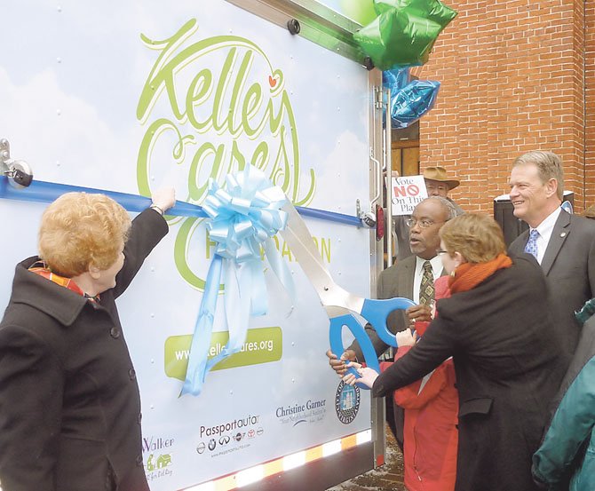 Councilwoman Del Pepper, Mayor Bill Euille and Vice Mayor Kerry Donley join Lindsay Swanson in cutting the ribbon to the new Kelley Cares Multi-Sensory Mobile Jan. 21 at City Hall.