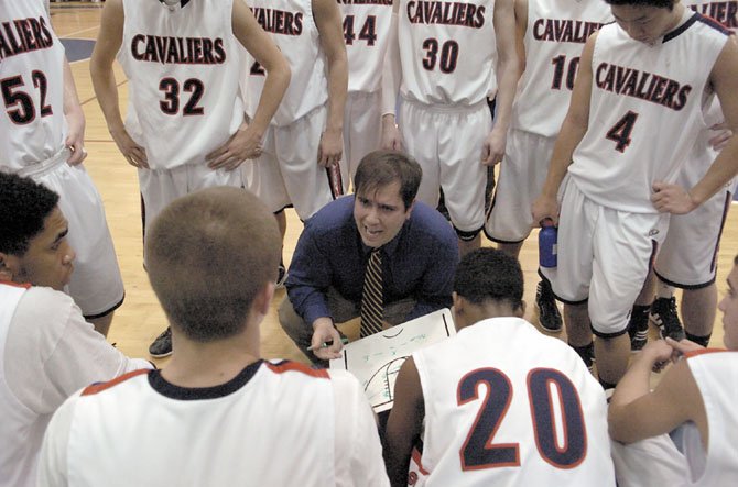 Woodson boys’ basketball head coach Doug Craig talks to the Cavaliers during a break in the action against T.C. Williams on Jan. 24.