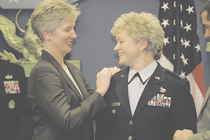 Kathy Knopf, left, pins colonel’s wings on her partner, Air force Col. Ginger Wallace, during Wallace’s December 2011 promotion ceremony in the Pentagon’s Hall of Heroes. Wallace and Knopf, who live in McLean, attended the State of the Union last week and sat in the first lady’s box. 