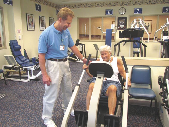 Fitness expert Brad Hibbs of Greenspring, a retirement community in Springfield (shown here with Greenspring resident Julia Gerow), says motivating seniors can be challenging.  