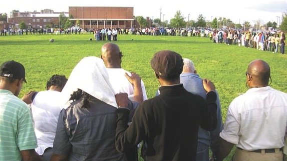 Hundreds gather for a candlelight vigil for Lenny Harris in September. 