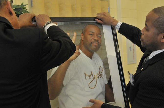 Tai Smith and Roy Priest place a photo of Lenny Harris.