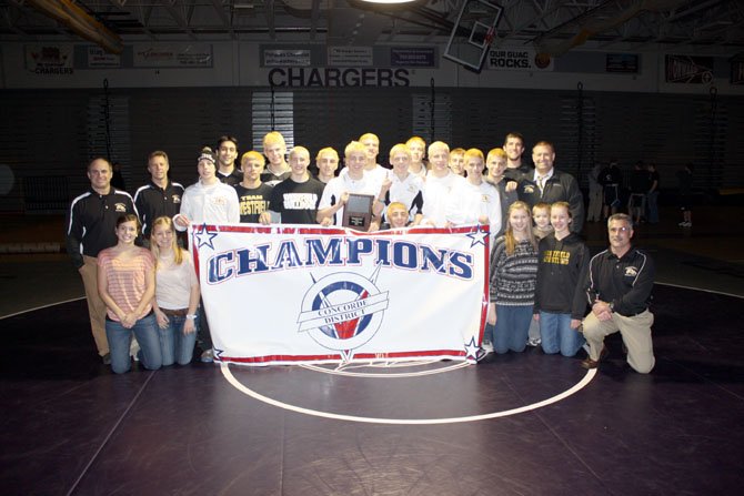The Westfield wrestling team showcases its championship banner last Saturday night.