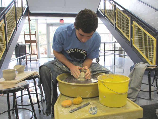 William Chanania, a Flint Hill senior, gives a demonstration on throwing clay. All components, including glaze, are safe, he said.

