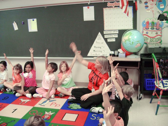 Francis Scott Key Elementary School teacher Briana Tavernier leads first grade students in a morning discussion. Experts say helping children succeed academically requires an open dialogue between parents, students and teachers.