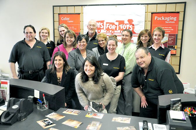 Staff from the South Lakes UPS Store, Reston elementary schools and other community groups at the UPS Store Friday, Feb. 10 after owner Hal Berens presented $10,000 worth of books to Lake Anne, Terraset and Forest Edge Elementary Schools, as well as Reston Interfaith. 