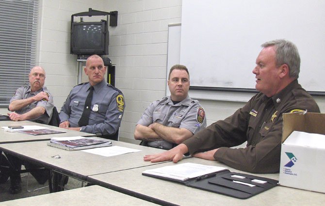 From left; PFC Wayne Twombly, Sgt. Robert Alessi and PCA Pete Katinsky listen while Lt. Col. James Whitley makes a point.