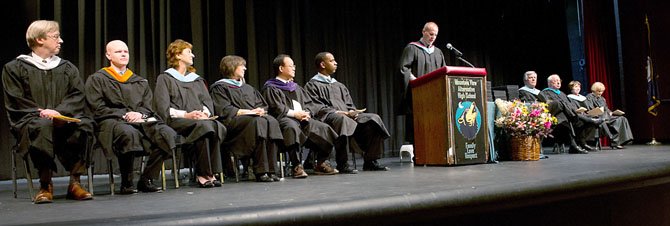 Several members of the Fairfax County School Board and senior administrators participated in Mountain View Alternative High School’s winter graduation. Seated, from left to right: School Board Member At Large Ted Velkoff, School Board Member At Large Ryan McElveen, Providence District School Board Member Patty Reed, Sully District School Board Member Kathy Smith, Vice Chairman of the School Board Ilryong Moon, Mountain View High School Principal Dave Jagels (standing), Fairfax County Public Schools Superintendent Dr. Jack Dale, COO Facilities and Transportation Services of FCPS Dean Tistadt, FCPS Assistant Superintendent Dr. Kim Dockery, and Fairfax County Division Counsel Anne Murphy. Also in attendance was Linda Burke, assistant superintendent of Cluster VII.