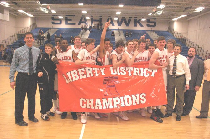 It was a jubilant McLean team which displayed its Liberty District championship banner following the double overtime win over the Rebels. 