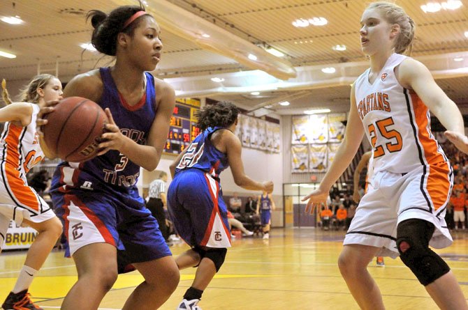 T.C. Williams junior Christian Roberts, left, is defended by West Springfield sophomore Amy Berglund during the Patriot District championship game on Feb. 17.