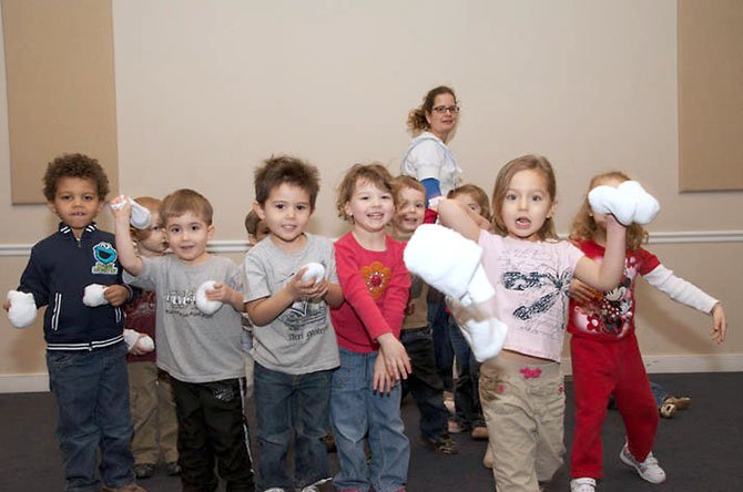 From left: Knollwood Community Preschool students - Isaac, Alemayehu, Toph Slingerland, Liam Roberts, Spencer Doll, Lyla Kelly, Owen Gabris, Elizabeth Zimmer, Emma Reynolds-MIllspaugh and Daphne Taylor have some indoor snowball fun thanks to Creative Movement teacher, Anne Margaret Ashley (back), who got inventive with white socks.  