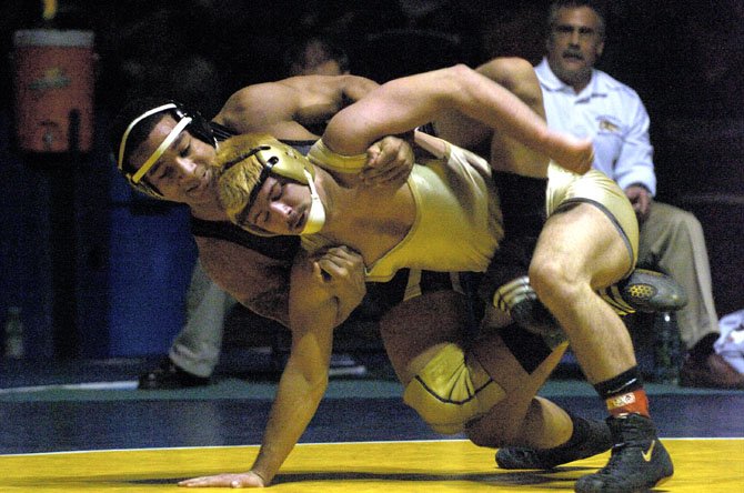 Westfield High senior Beau Donahue (front) captured the state title at the 152-pound weight class at last Saturday’s Virginia State Wrestling Championships, held at Robinson Secondary. Donahue, who captured the Northern Region crown two weeks ago, won all four of his state matches, including a 3-1 finals victory over senior Kevin Johnson (pictured) of Forest Park High. His three prior wins came over Matoaca’s Michael Ramos, 18-6; Orange County’s Ryan Almond, 6-4; and in the semifinals Thomas Dale High’s Alex Turley, also 6-4.     