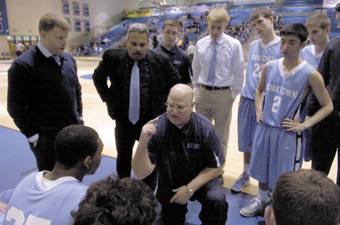 Yorktown boys’ basketball coach Rich Avila talks to the Patriots during their regional quarterfinal matchup with Fairfax on Feb. 22.