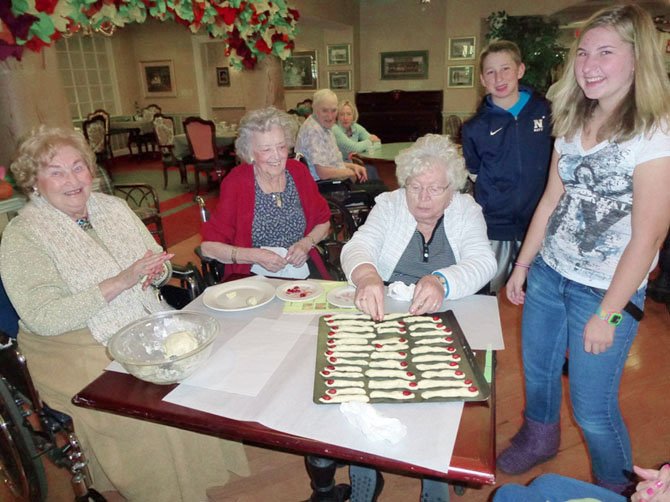 Maryann Rigo and residents at the Sunrise Senior Living are working on scary treats for a resident Halloween extravaganza. Residents Joan Gay, Lucille Kilmain and Fern Lacangelo mix the dough for this "finger" food and assemble them on a cookie sheet for baking.