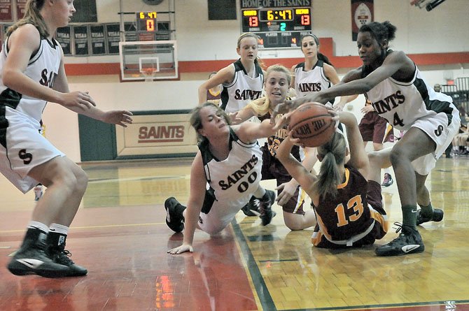 St. Stephen’s & St. Agnes’ Alexis Sargent (00) and Dhyamond Crenshaw, right, go after the ball, which is controlled by Bishop Ireton’s Isabelle Kendall on Feb. 28.