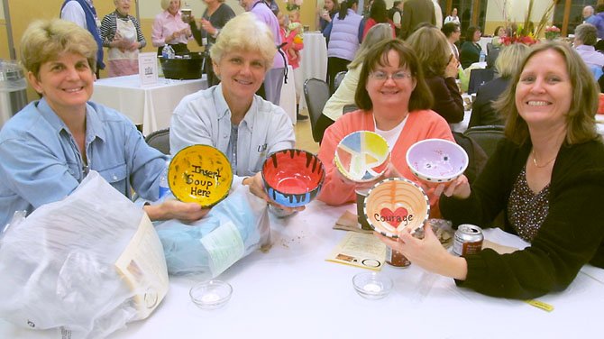 Friends Carol Valentine and Tori Beuzese of Lorton, Alicia Preito and and Chris Cohen of Fairfax show off the bowls they selected at the Empty Bowls fundraiser. 

