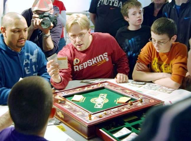 Matthew McFarland, 14, of Lorton (right) negotiated his way to the top of the real-estate pyramid during the fifth annual Monopoly Tournament to Benefit Habitat for Humanity. The event was held at the Workhouse Arts Center on Saturday, Feb. 25. Brian Miller of Woodbridge (center) took fifth place and Bernard Sloan of Lorton (left), a tournament veteran took fourth place.  