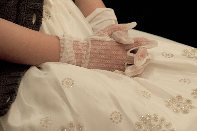 Wearing a crinoline party dress and white gloves, Erika Wu of McLean is sitting pretty during the 17th annual Jon D. Williams Spring Cotillion March 2 at the Washington Golf & Country Club in Arlington. 