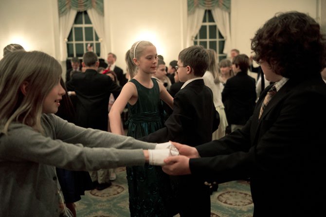 Claire Sawyer of Arlington and Caleb Himes of McLean (couple in center); and Marina Terry of McLean  and Julien Barakat of Vienna (foreground) practice the fox trot during the 17th annual Jon D. Williams Spring Cotillion March 2 at the Washington Golf & Country Club in Arlington. The party was the finale of five weeks of social skills classes, including ballroom dancing, table etiquette, character and civility. 
