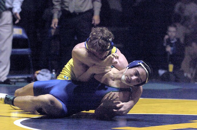 Ryan Forrest (bottom), South Lakes’ outstanding wrestler, got into trouble early on in his state finals match against Hopewell’s Cody Allala (top) when he was turned onto his back. But Forrest, who battled adversity throughout the entire postseason, prevented the pin and went the distance in the title match loss. 