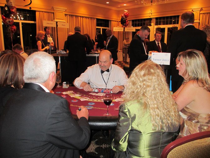 Rotarian Howard Svigals deals at a blackjack table. 