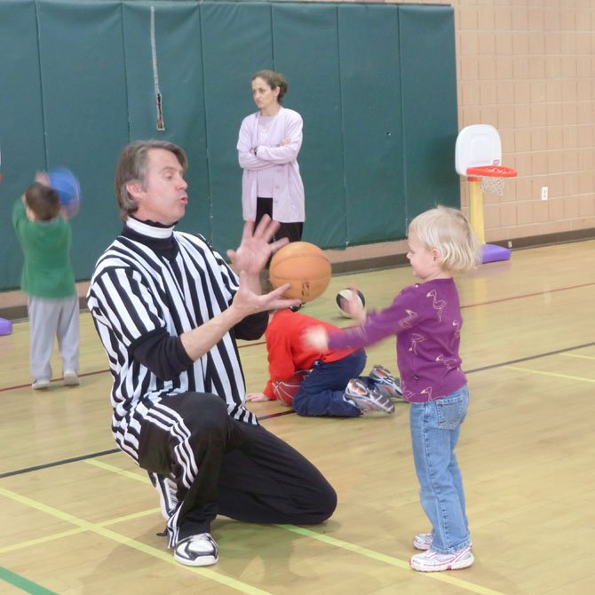 Coach Doug Wilson plays with the younger campers.
