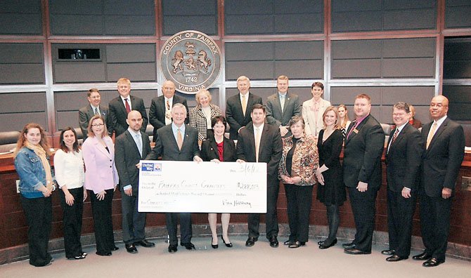 Board of Supervisors Chairman Sharon Bulova (center), accepts a $280,000 check from Bill Hanbury (next to the chairman, on her left), President of the United Way of the National Capital Area. Front row, from: Marcia DiTrapani, Herndon-Reston FISH, Inc.; Krista Osterthaler , The National Capital Poison Center; Jaime Farrant, Ayuda; Carol Loftur-Thun, The Women’s Center; Joel Bedknoski, Alzheimer’s Family Day Center; Kimberely Jappell, NOVAM; Elizabeth Doherty, KEEN Greater DC;United Way Fairfax Regional Council Co-Chair Paul Taffe of Wells Fargo; United Way Regional Council member Jeff Lear of Lear Communications; and Jim Shelton of Orange Panda. 

