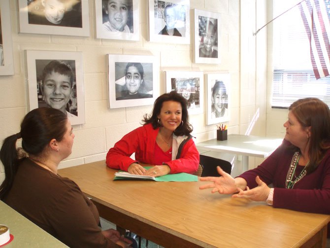 Spring Fling chairperson, Frances Sankey, meets with school staff to go over auction plans.