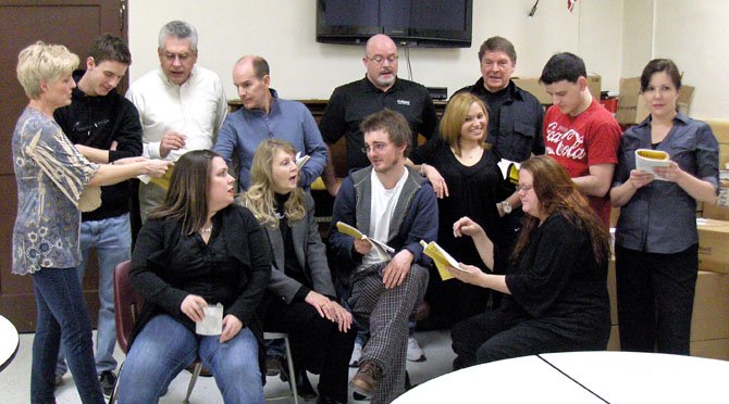 Members of The Alliance Theatre portray the cast of a summer-repertory company rehearsing for a show.
