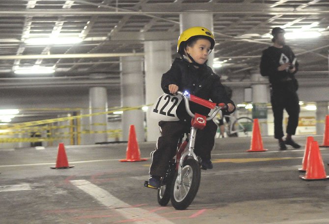 Wesley Ochsendorf takes the turn near the finish line in the little children’s derby race.