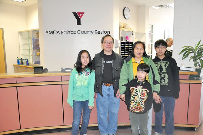 From left, Tiffany Ngoc Thuan Thai, 11, Trung Anh Van Thai, Phoung Nga Thi Tran, Stewart Trung Thang Thai, 9 and David Trung Tien Thai at the Reston YMCA Saturday, March 10. The family was one of several that were awarded YMCA memberships through the YMCA and a partnership with Reston Interfaith. 