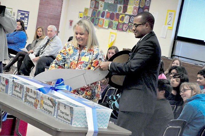 Lisa Lombardozzi, president of LINK, pictured here with Marty Smith, Cluster One assistant superintendent for Fairfax County Public Schools, on March 12, 2012, as they cut the ribbon on the new food donation bins at Dranesville Elementary School.
