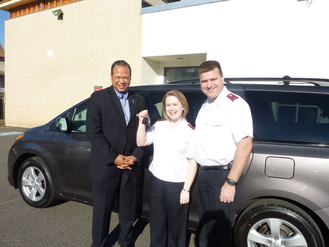 Alexandria Salvation Army board chairman Walter Clarke, left, joins Lieutenants Sherri and Trey Jones March 9 in celebrating the acquisition of a new van from Jack Taylor's Toyota. The Corps won the van by logging the most volunteer hours in the DC region during the 2011 Red Kettle Campaign.