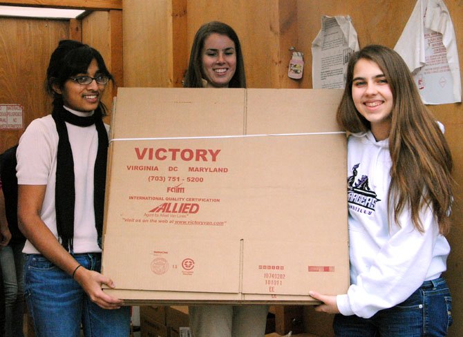 From left: Priyanka Srinivasan, Christy Quetsch and Rachel Dunning will soon help pack these flattened boxes.
