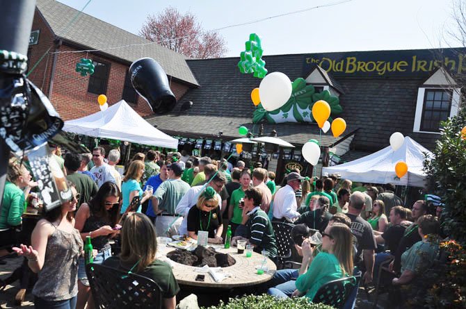 Patrons of The Old Brogue in Great Falls fill the front porch during their annual St. Patrick’s Day celebration Saturday.