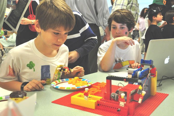 From left, Harrison Langpaul and Alec Butler, students at Colvin Run Elementary School, examine their potato chip factory made of Lego bricks during the Junior First Lego League Expo Saturday, March 17 at Colvin Run Elementary. 