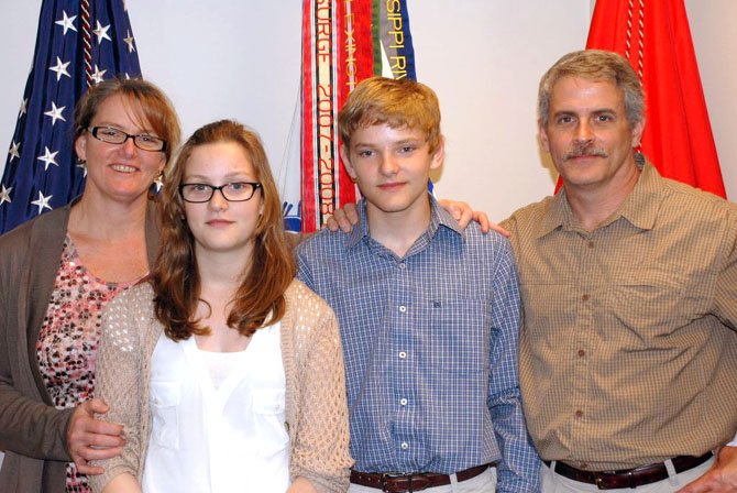 Travis Catina with his family: mother, Cate, who is a lieutenant colonel currently serving at Ft. Belvoir; sister, Rebecca, a sixth grader at Lorton Station; and father, Rich, who retired this year after 20 years of service in the Army as a member of the Special Forces.

