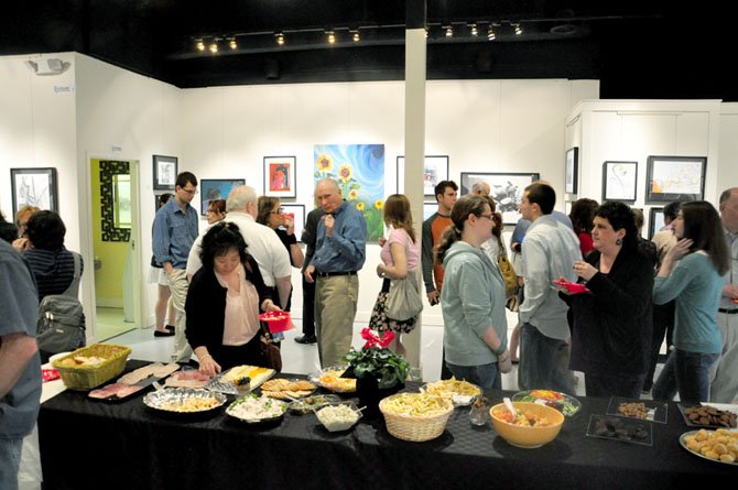 Herndon High School students, families and faculty gather at Herndon ArtSpace for the reception for the annual senior art show Friday, March 16. 